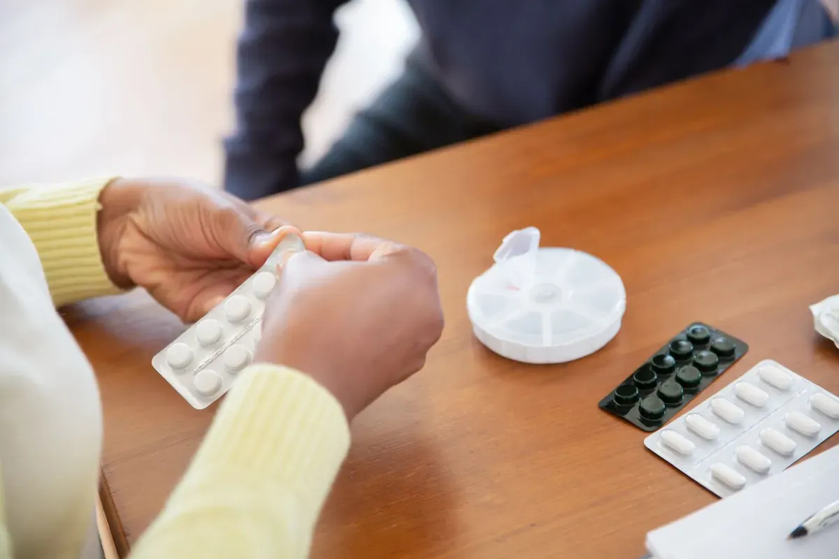 يدان تفرزان أقراصًا من شرائط على طاولة